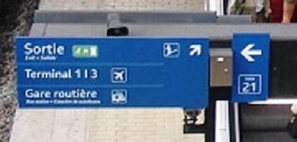 exit sign after arriving at  Charles de Gaulle 1 train station with directions to terminals 1 & 3