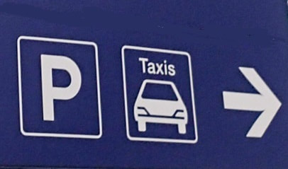 Direction sign to parking and taxis at Charles de Gaulle Airport in Paris